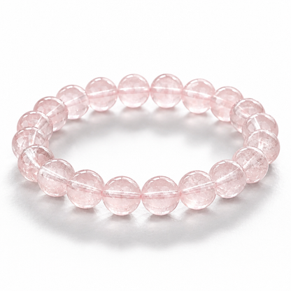 Madagascar Rose Quartz bracelet with soft clean milky-pink 7.5mm beads on white surface