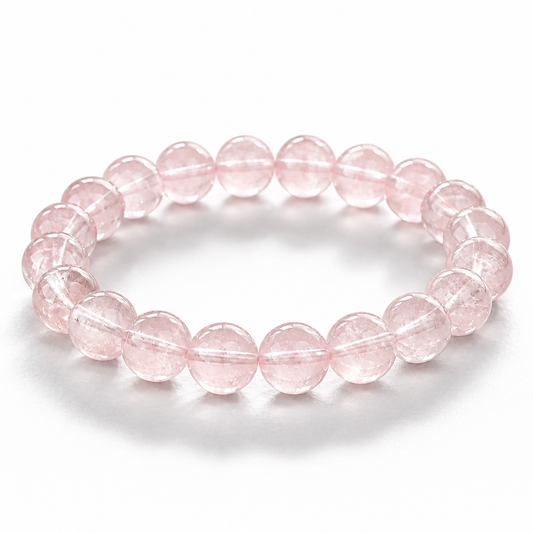 Madagascar Rose Quartz bracelet with soft clean milky-pink 7.5mm beads on white surface