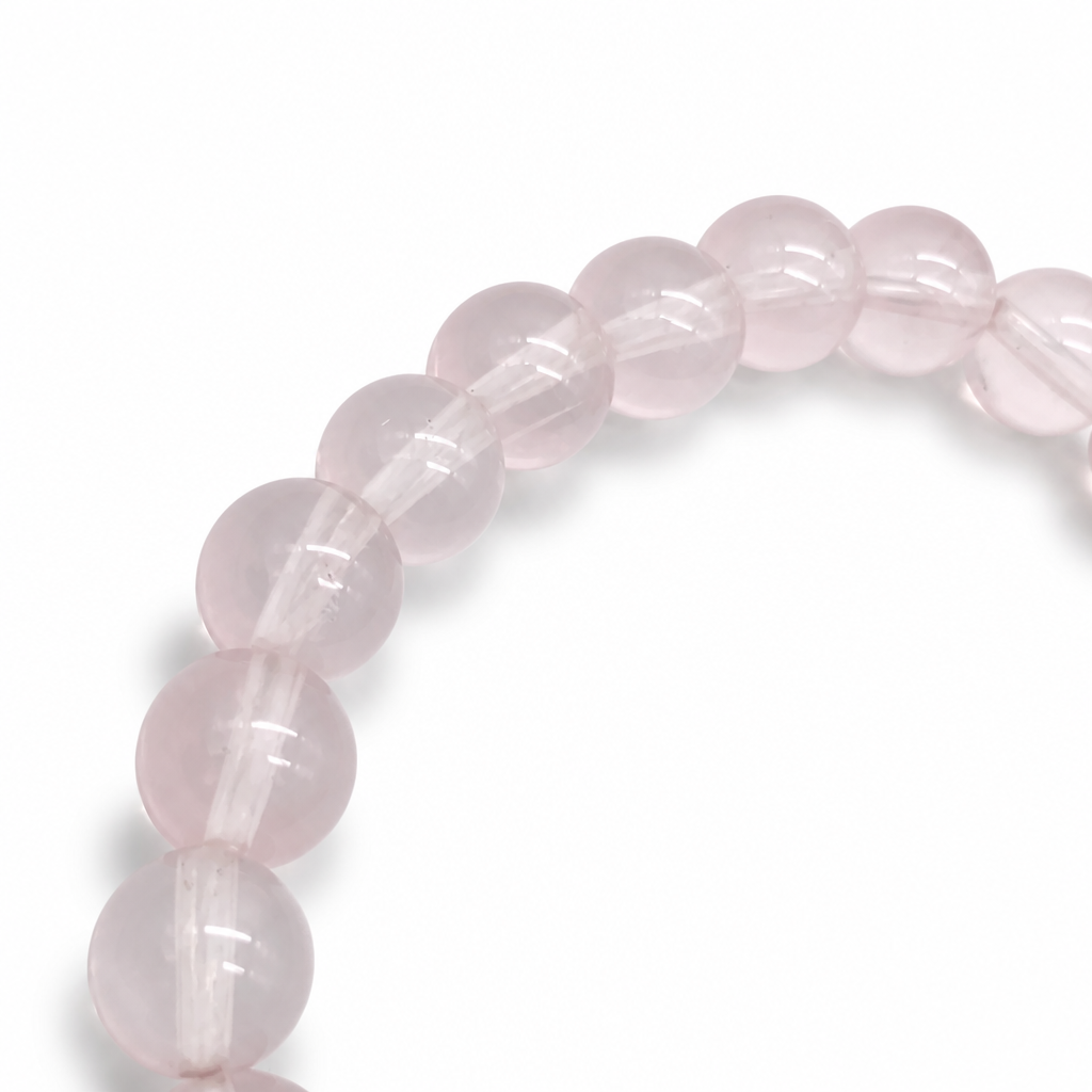 Star Rose Quartz bracelet resting flat showing cool lavender-pink bead colour in natural light