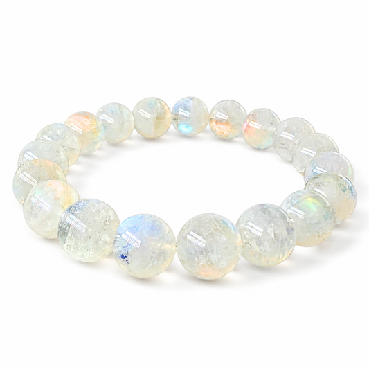 Close-up of rosy-pink adularescence drifting across a 10mm Madagascar Moonstone bead
