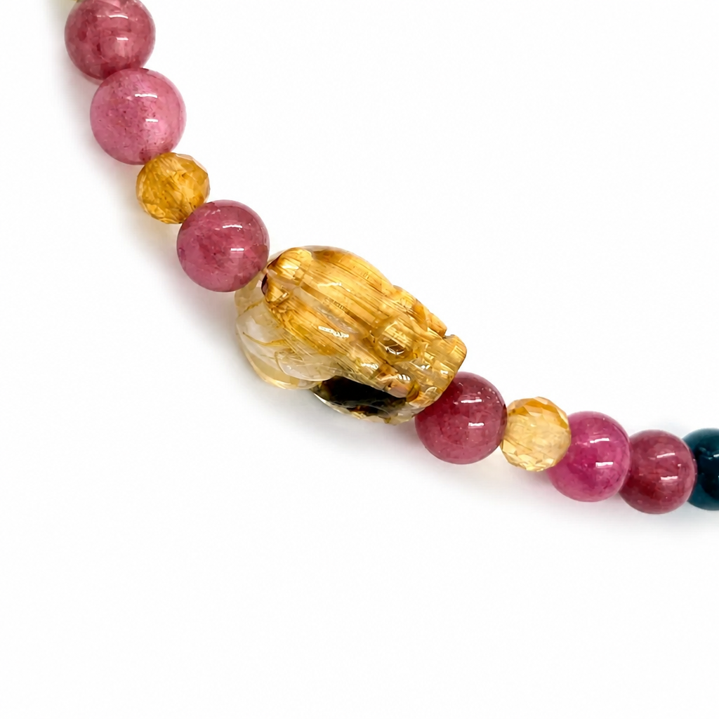 Close-up of rainbow tourmaline 4mm beads in pink green teal gold and blue