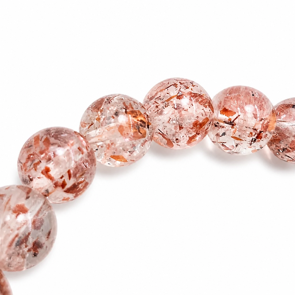 Rare lepidocrocite in quartz bracelet held to the light