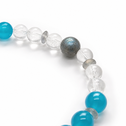 Side view of the Verdant Voyager bracelet showing mixed 5-8mm bead sizing on a pale surface