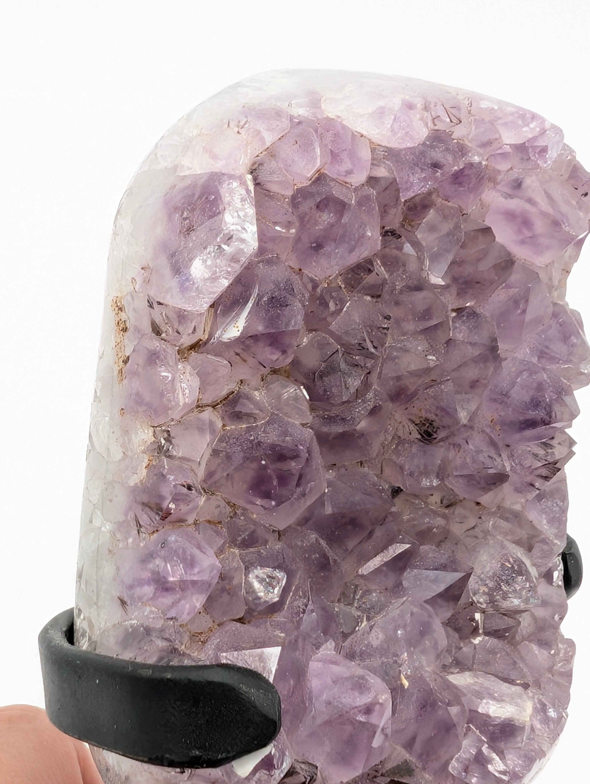 Natural symbiotic mineral inclusions at the base of the lavender amethyst spire