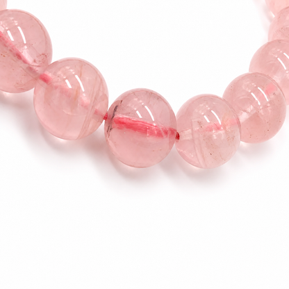 Warm translucent rose quartz beads catching the light