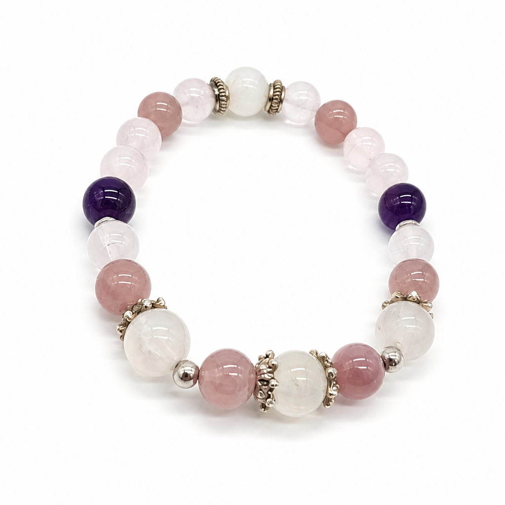 Moonstone bead showing blue-white sheen beside amethyst