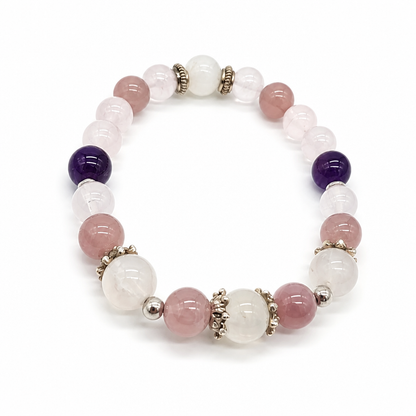 Moonstone bead showing blue-white sheen beside amethyst