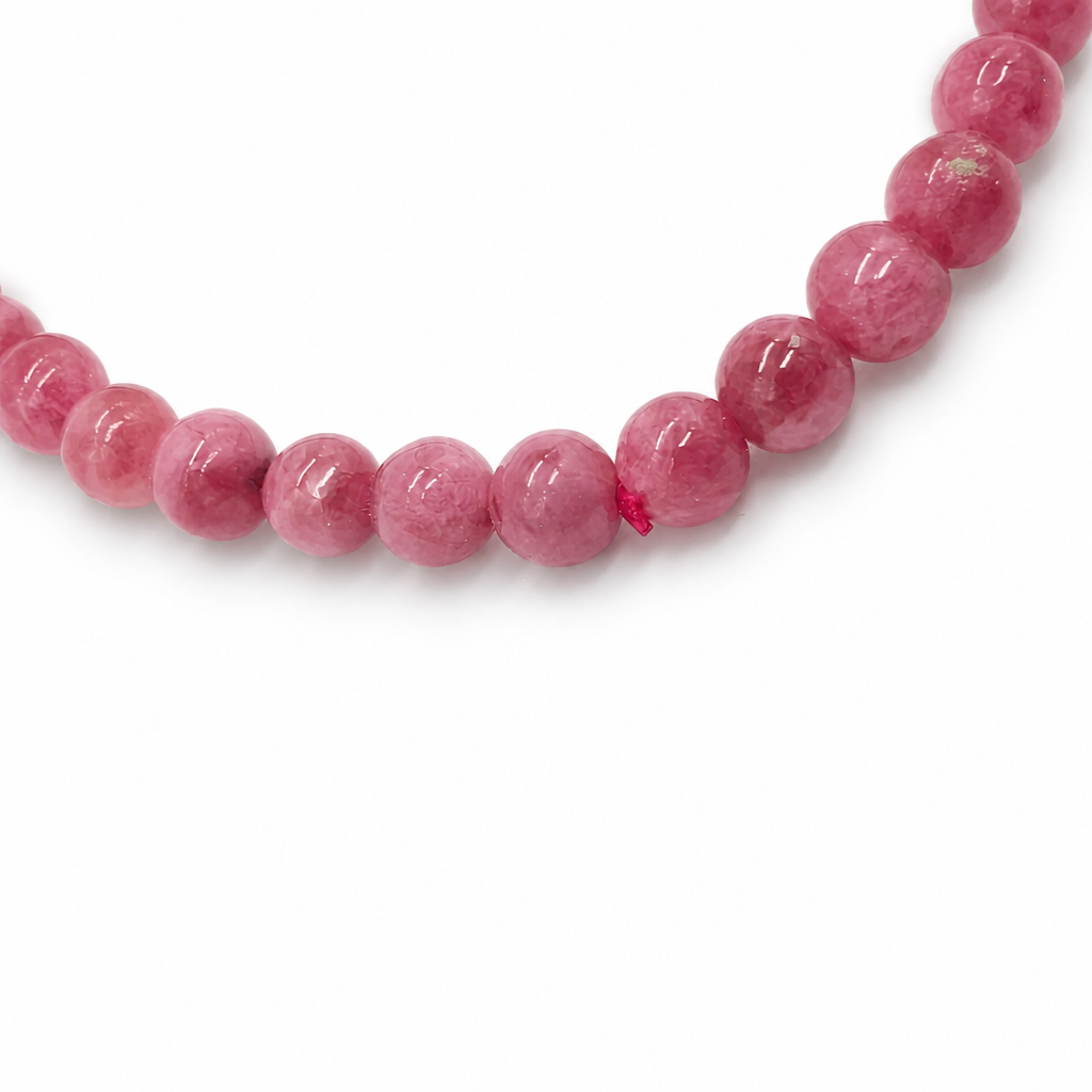 Rose-pink rhodonite bead with black veins
