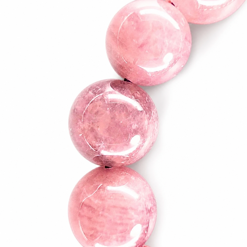 Angled view of Madagascar violet star rose quartz beads catching the light