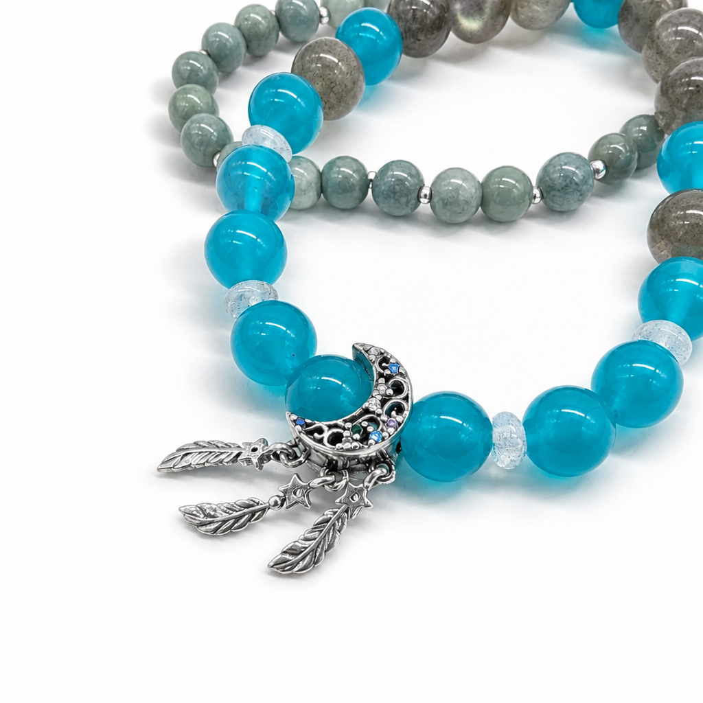 Moonlit Oasis designer bracelet worn on the wrist showing green tones and dreamcatcher charm