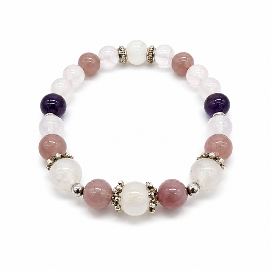 Close-up of deep violet amethyst, adularescent moonstone and lavender rose quartz beads