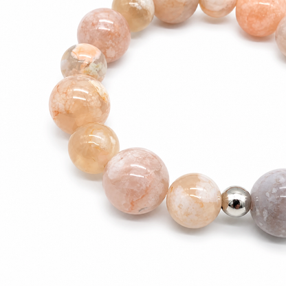 Flower agate bracelet with silver charm curved on white