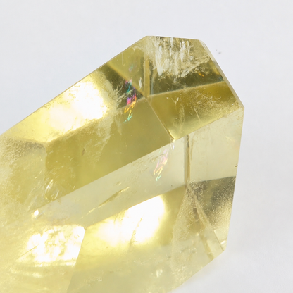 Angled view of the Brazilian Citrine point catching light across its natural surface
