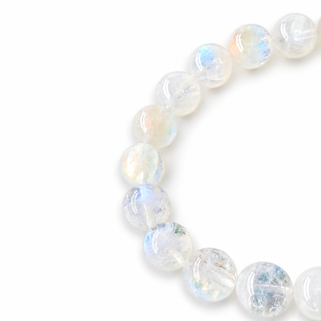 Pink-blue adularescence shifting across Madagascar Moonstone beads in angled light