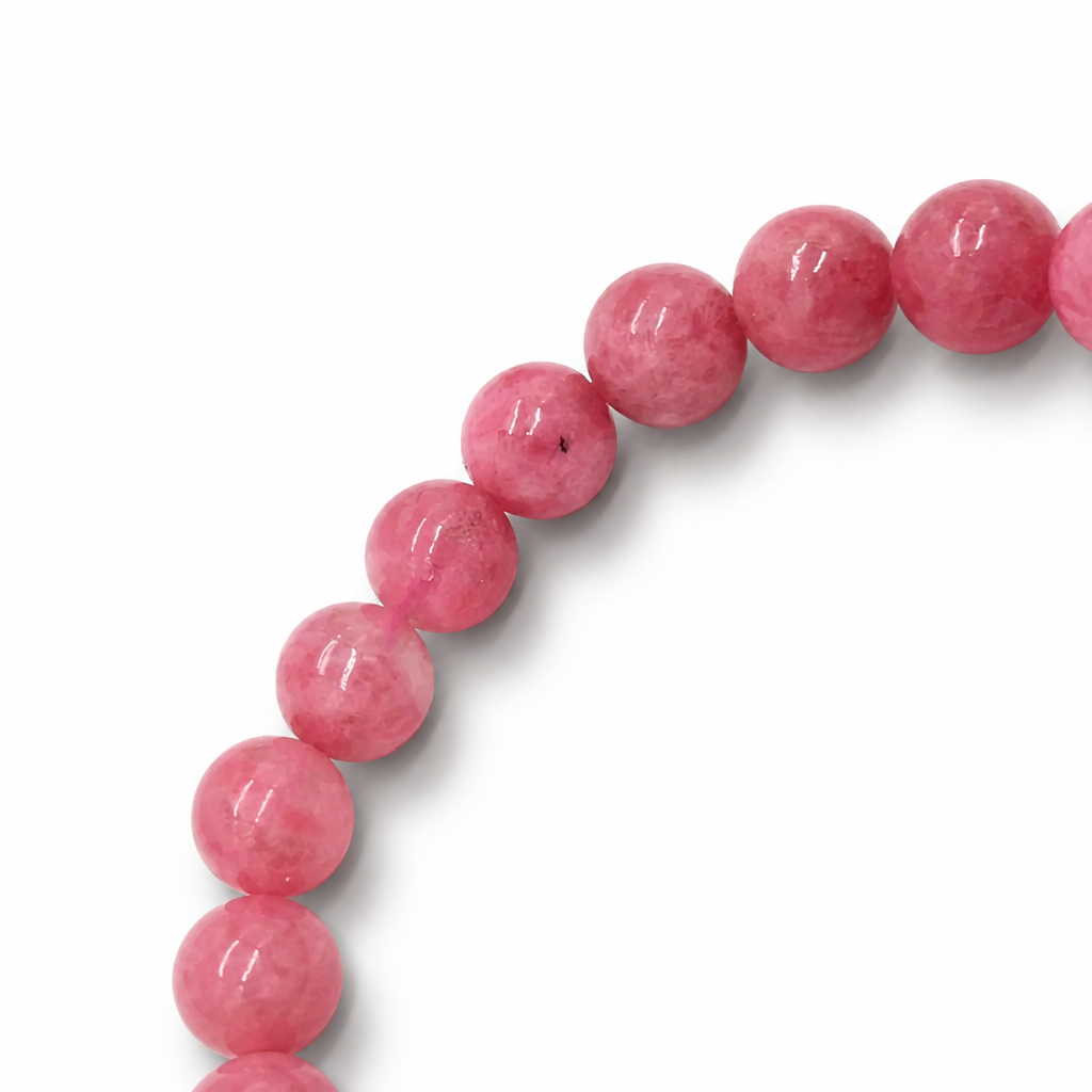 Side view of Rhodonite Gradient bracelet showing 7.5mm bead depth and colour range on pale surface