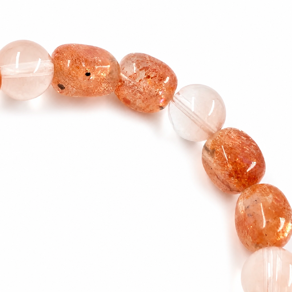 Warm amber sunstone bead showing natural glittering aventurescence in light