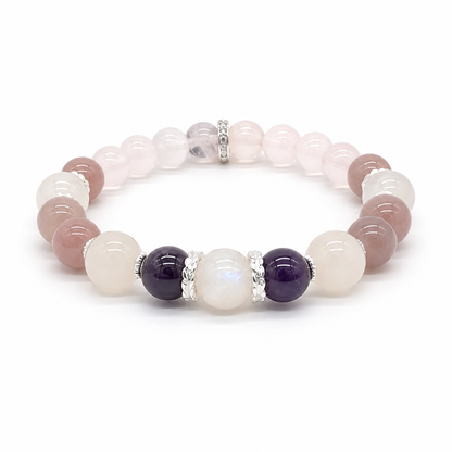 Close-up of deep violet amethyst beads alongside soft blush Madagascar rose quartz