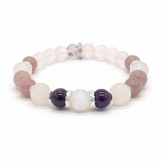 Close-up of deep violet amethyst beads alongside soft blush Madagascar rose quartz