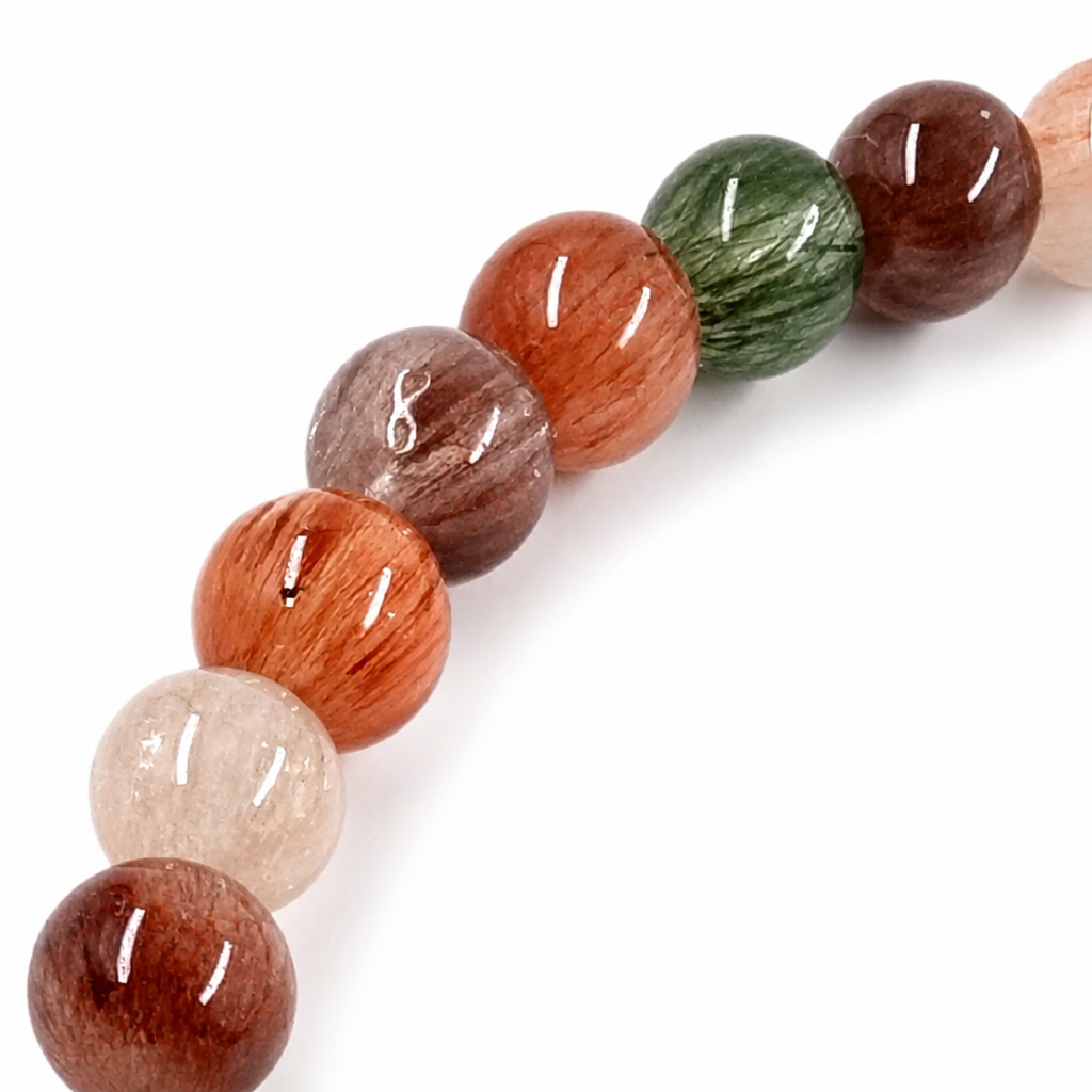 Water-clear Rabbit Hair Quartz beads with fine rose-gold inclusions on white