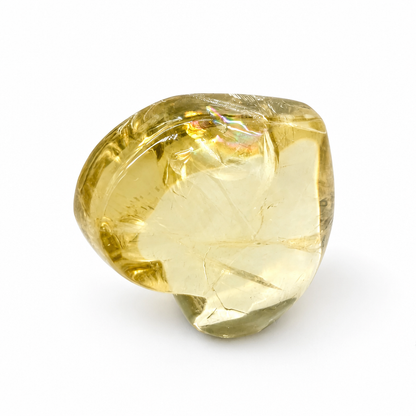 Hand-carved citrine heart with high-shine polish resting on a pale surface