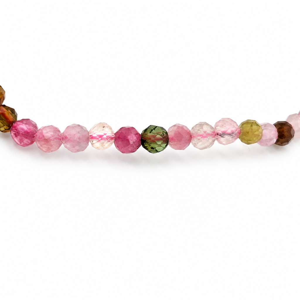 Prismatic light play across faceted tourmaline beads