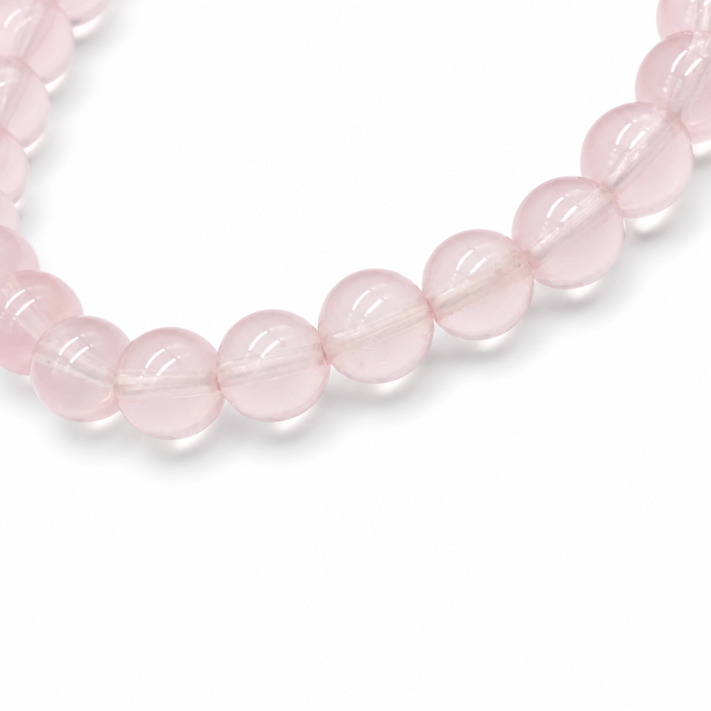 Star Rose Quartz bracelet worn on the wrist tilted to show asterism star in natural light
