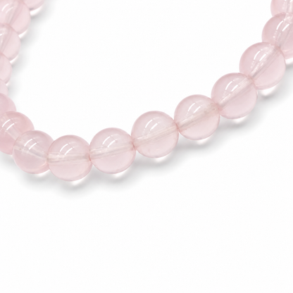 Star Rose Quartz bracelet worn on the wrist tilted to show asterism star in natural light
