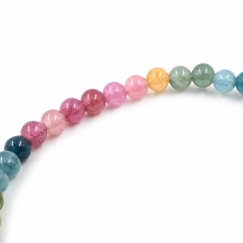 Pink rose tourmaline beads alongside green and teal in the rainbow bracelet