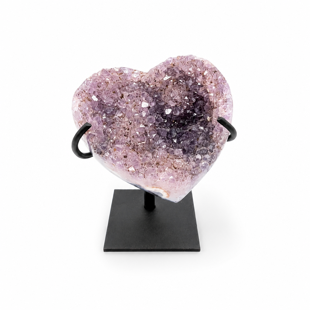 Gradient Amethyst cluster with pink-to-violet colour transition on a wooden stand