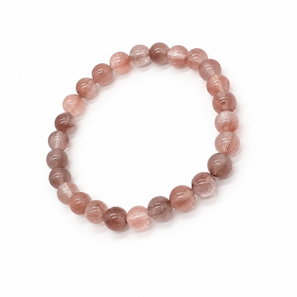 Fine red hematite fibres running through a quartz bead