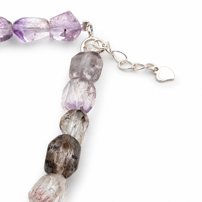 Melody Stone bracelet held in the hand, showing the full run of mixed-tone nuggets