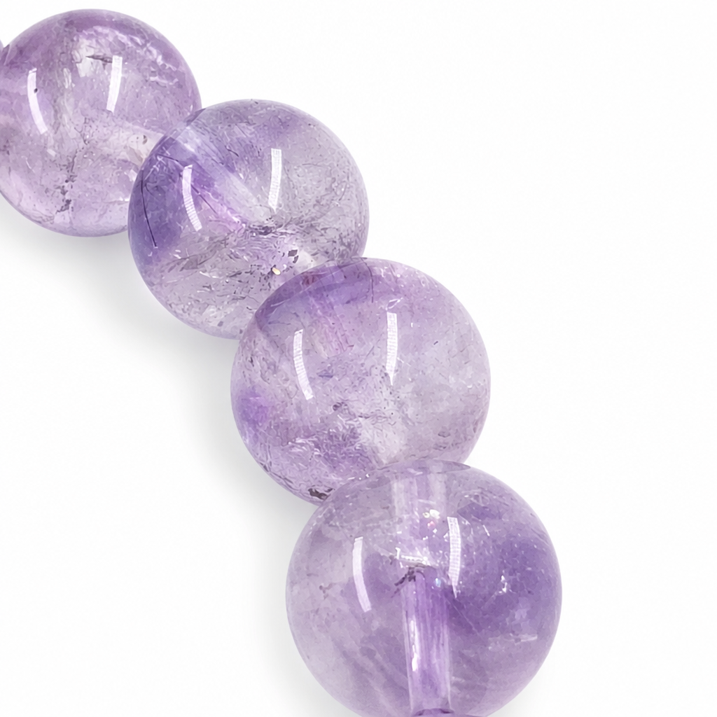 Angled view of the Super Seven bracelet catching light across deep violet beads
