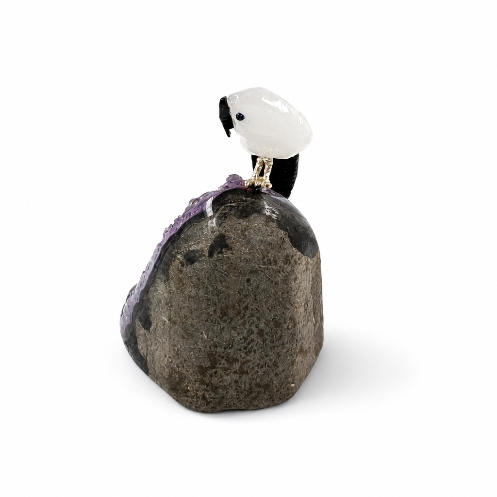 Side view of the amethyst parrot specimen showing full height on a pale surface