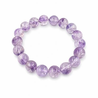 Super Seven Melody Stone bracelet with deep violet and multi-mineral inclusions on white