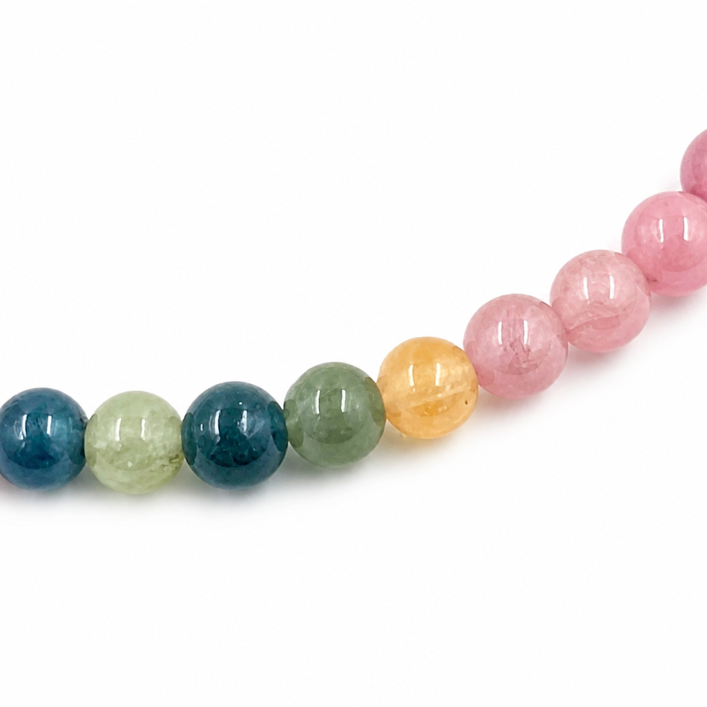 Side view of the rainbow tourmaline bracelet with golden Pixiu charm detail