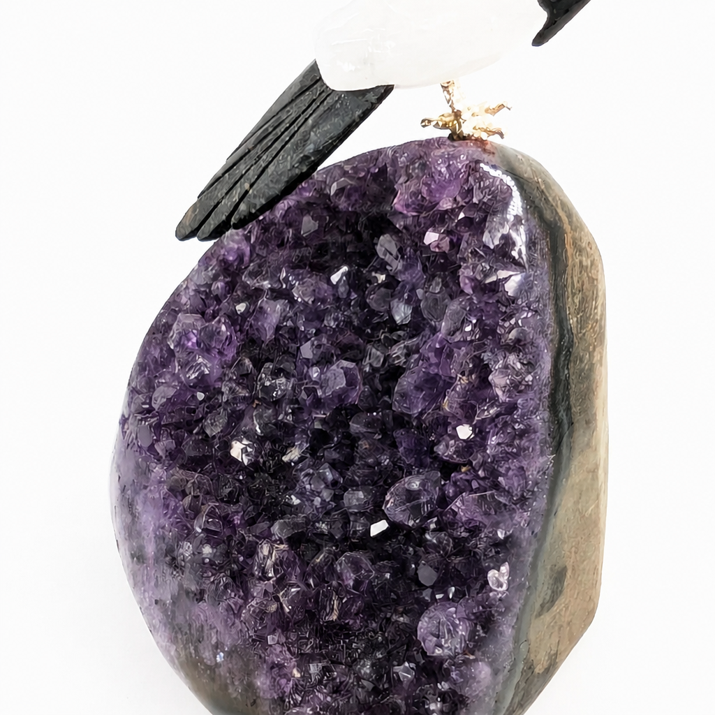 Detail of the hand-finished crystal parrot carving on the amethyst cluster