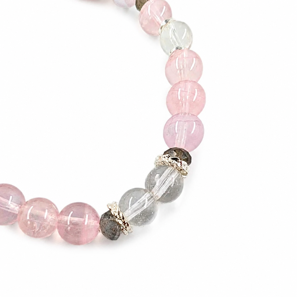 Purple rose quartz and clear quartz designer bracelet on a white background