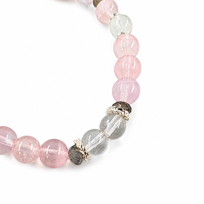 Purple rose quartz and clear quartz designer bracelet on a white background
