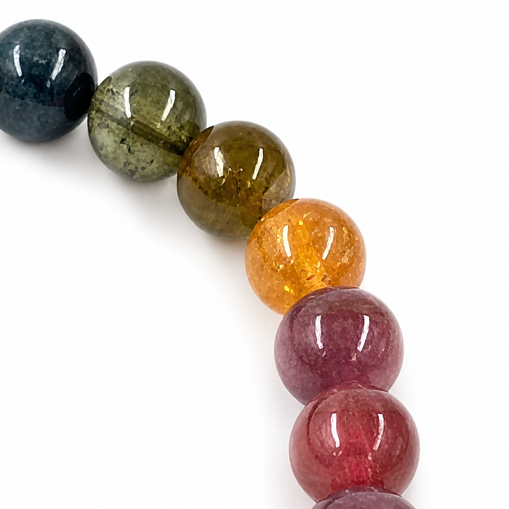 Handmade natural rainbow tourmaline crystal bracelet by Aura Lune on white background