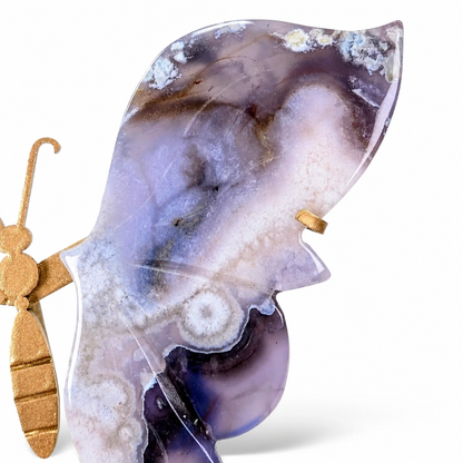 Gold butterfly stand holding the natural blue agate specimen