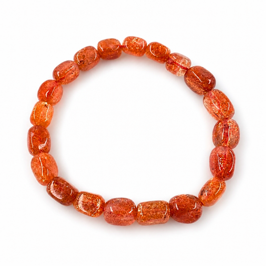 Close-up of amber-orange sunstone beads with copper glitter