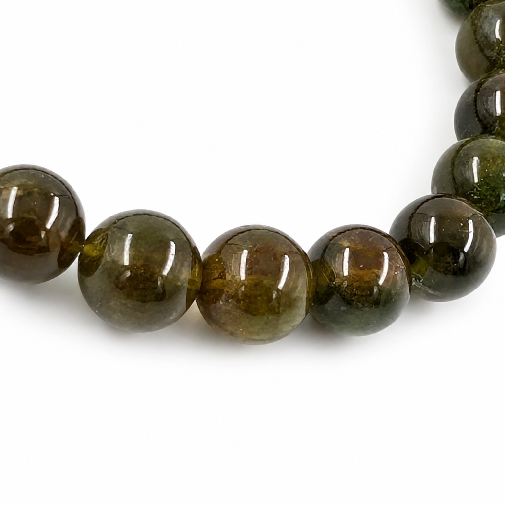 Angled view of the Green Tourmaline bracelet catching light to reveal glassy depth