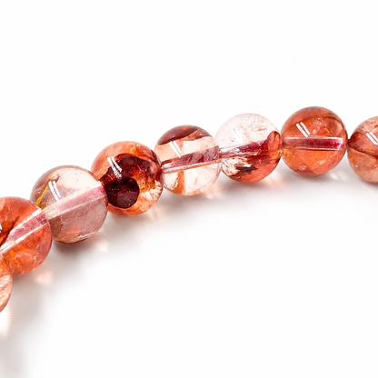 Hematite flames running through a fire quartz bead
