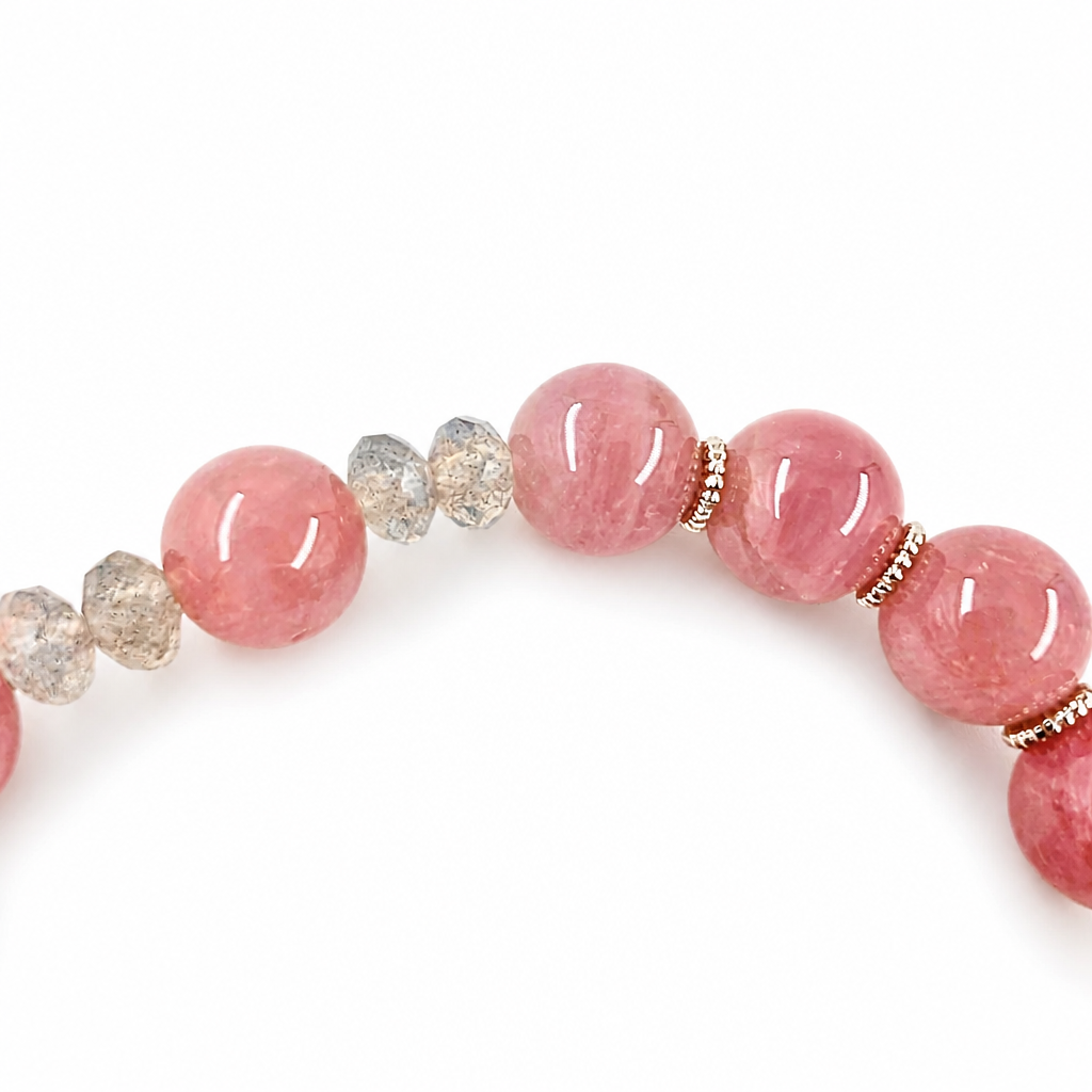 Detail of rose quartz beads and gold-and-silver floral charms
