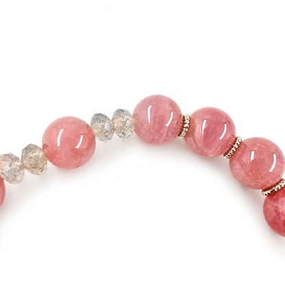 Detail of rose quartz beads and gold-and-silver floral charms