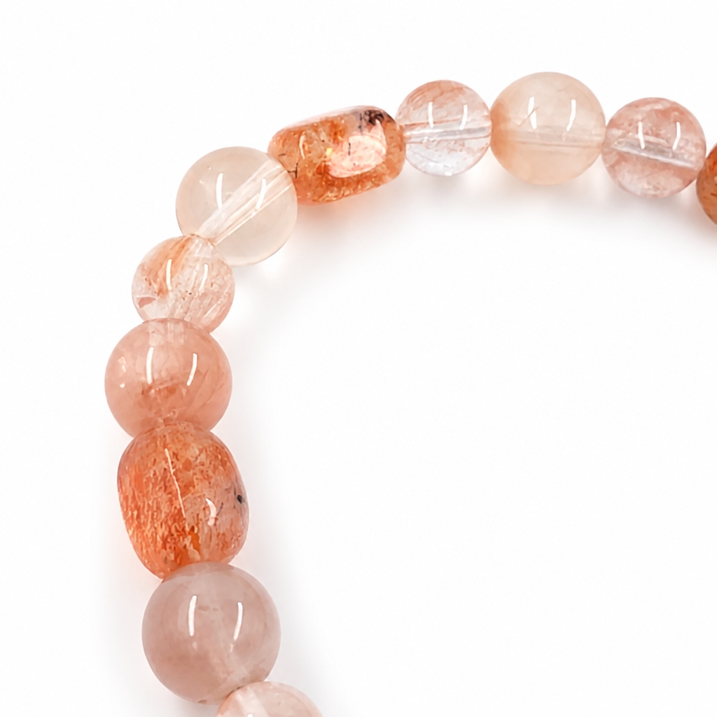 Deep red-orange sunstone bead showing intense aventurescence shimmer in direct light