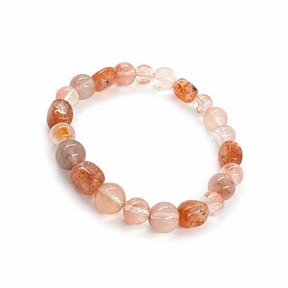 Red Sunstone and Rabbit Hair Quartz bracelet worn on the wrist in natural light