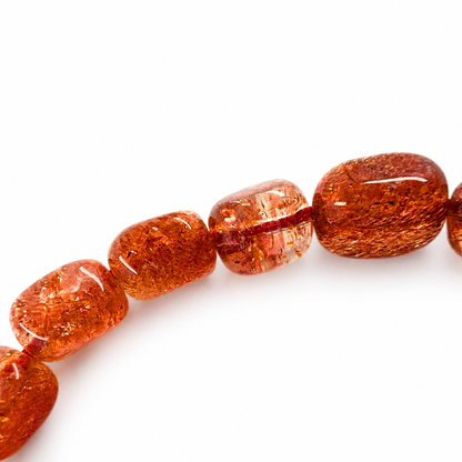 Warm amber sunstone bracelet curved on white