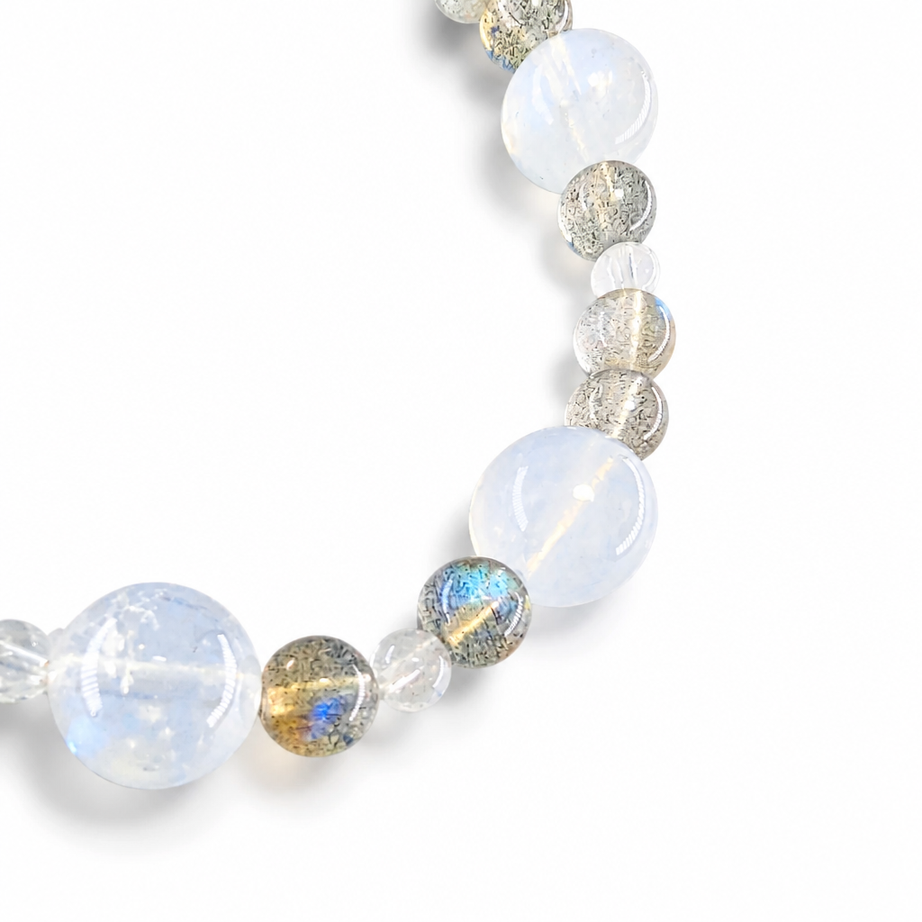 Soft white to grey Indian Moonstone beads with inner blue glow on white background
