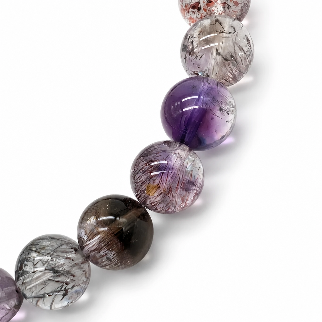 Transparent seven-mineral quartz beads catching light